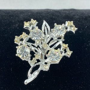 Vintage silver tone floral spray brooch with clear rhinestones